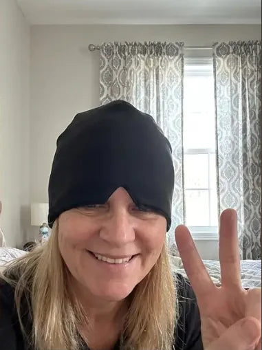 NuraCool customer smiling while wearing a black cooling cap