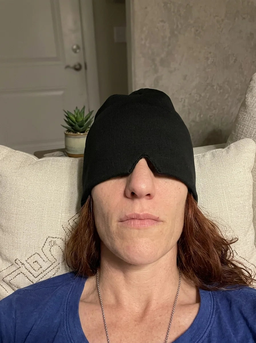 NuraCool customer resting with a black cooling cap positioned over her eyes
